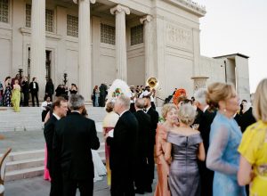 Wedding guests enjoying cocktail hour outside the front of the New Orleans Museum of Art.