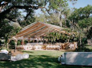 Beautifully decorated wedding reception tent at the New Orleans Museum of Art with elegant florals and tables.