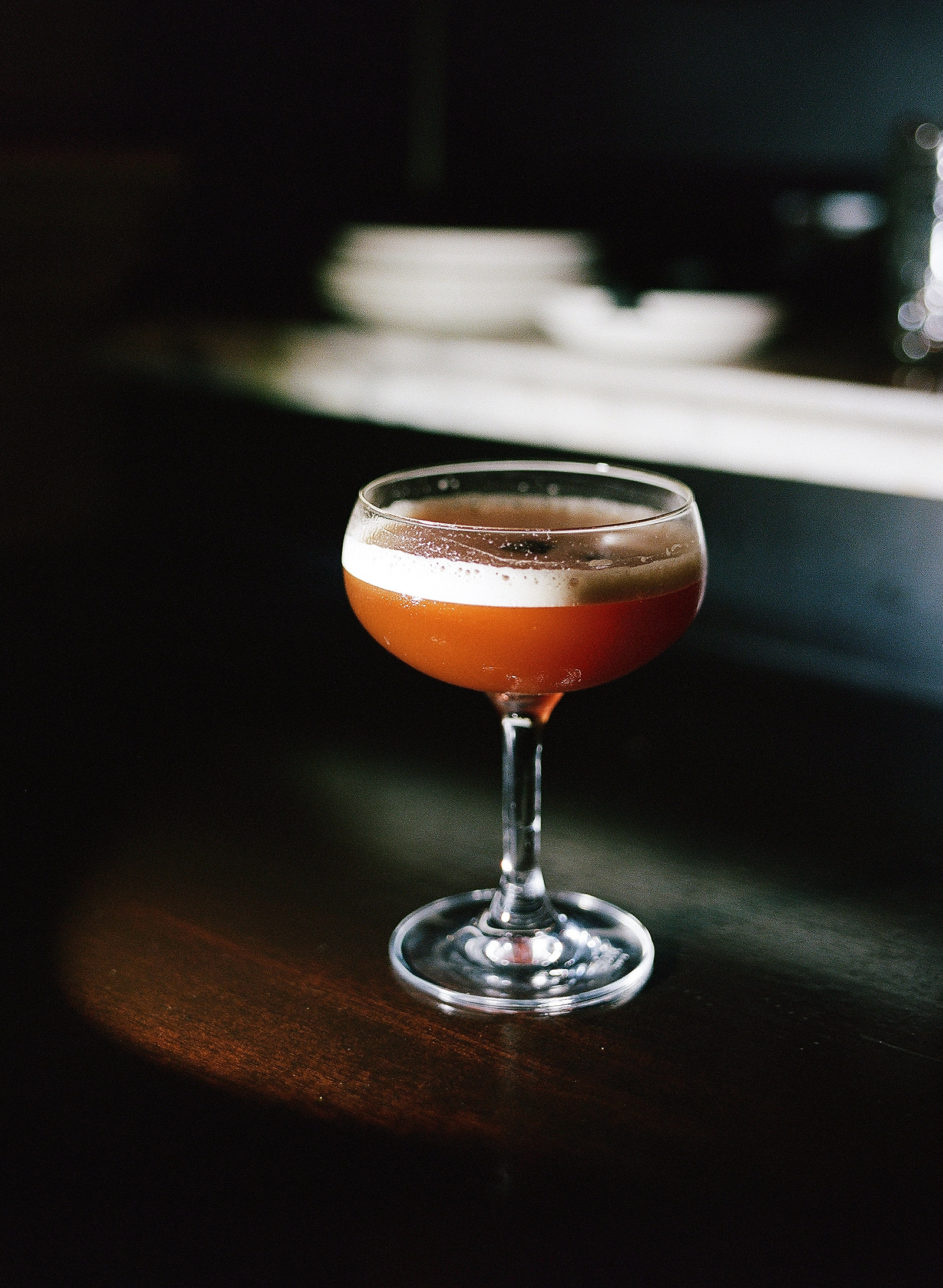 Amaretto Sour on a mahoghany bar