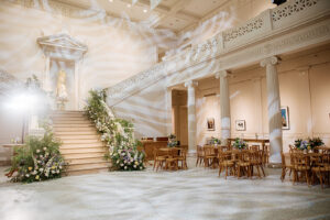 Elegant wedding florals decorating the staircase inside the New Orleans Museum of Art for a NOMA wedding.